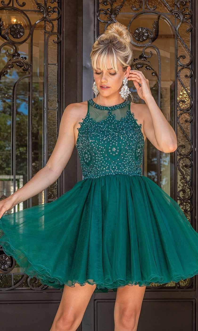 A woman in a Beaded Embroidered Lace Short Babydoll Party Dress poses before ornate metal doors, elegantly holding the skirt and touching her hair.