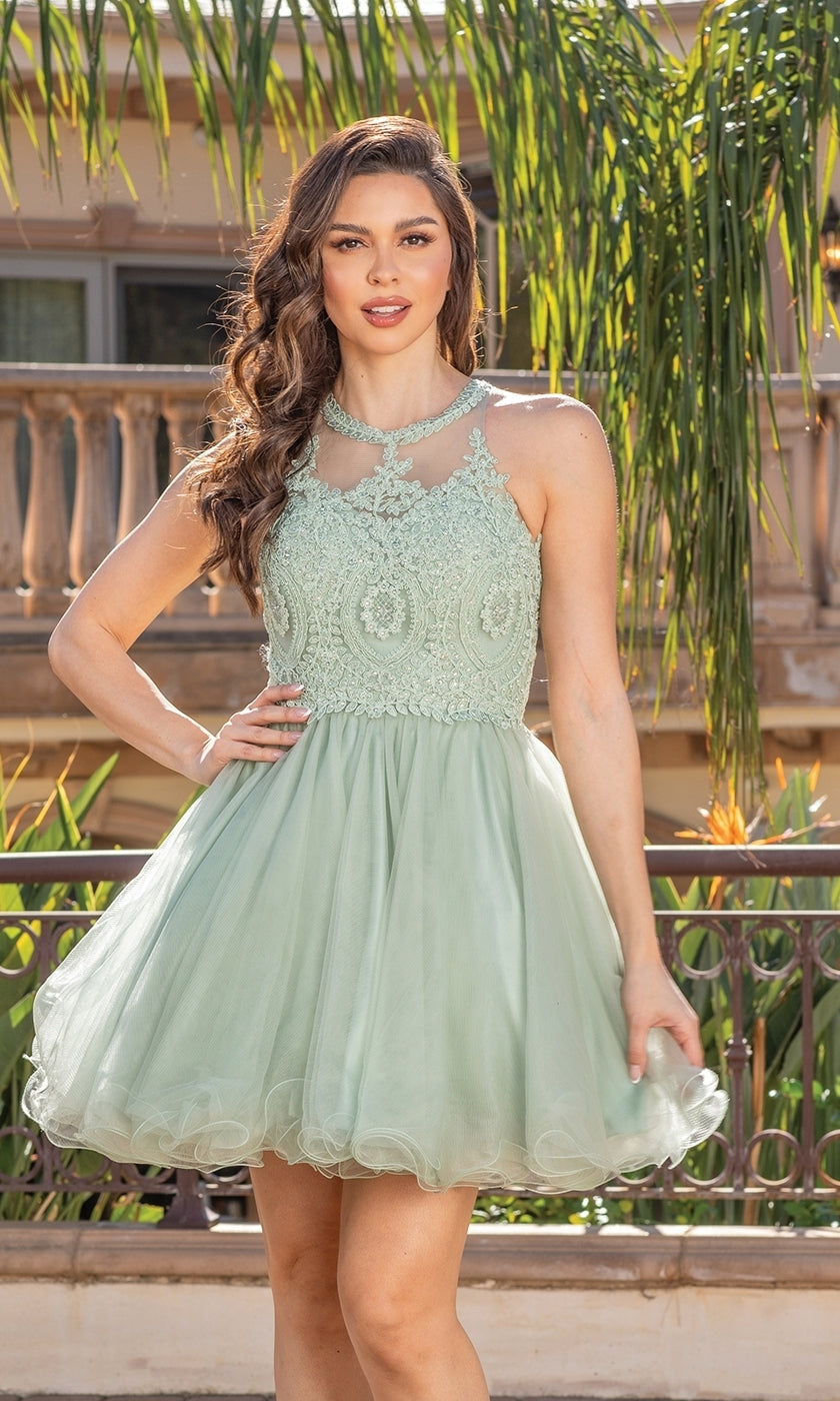 A woman stands outdoors before a balcony and palm trees, wearing the Beaded Embroidered Lace Short Babydoll Party Dress in light green, sleeveless with lace and tulle details and a beaded bodice.