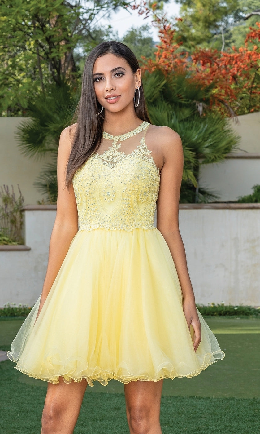 A woman stands outdoors wearing the Beaded Embroidered Lace Short Babydoll Party Dress, featuring a sleeveless, knee-length yellow design with lace details, a sheer neckline, and a delicately beaded bodice.
