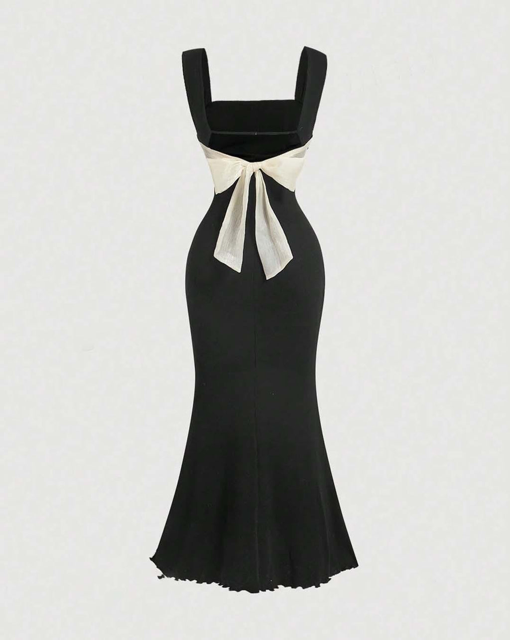 A black mermaid dress featuring a prominent white bow at the back, elegantly designed for formal occasions