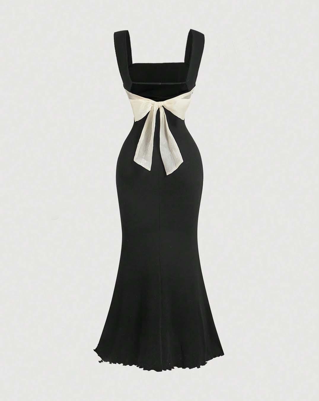 A black mermaid dress featuring a prominent white bow at the back, elegantly designed for formal occasions