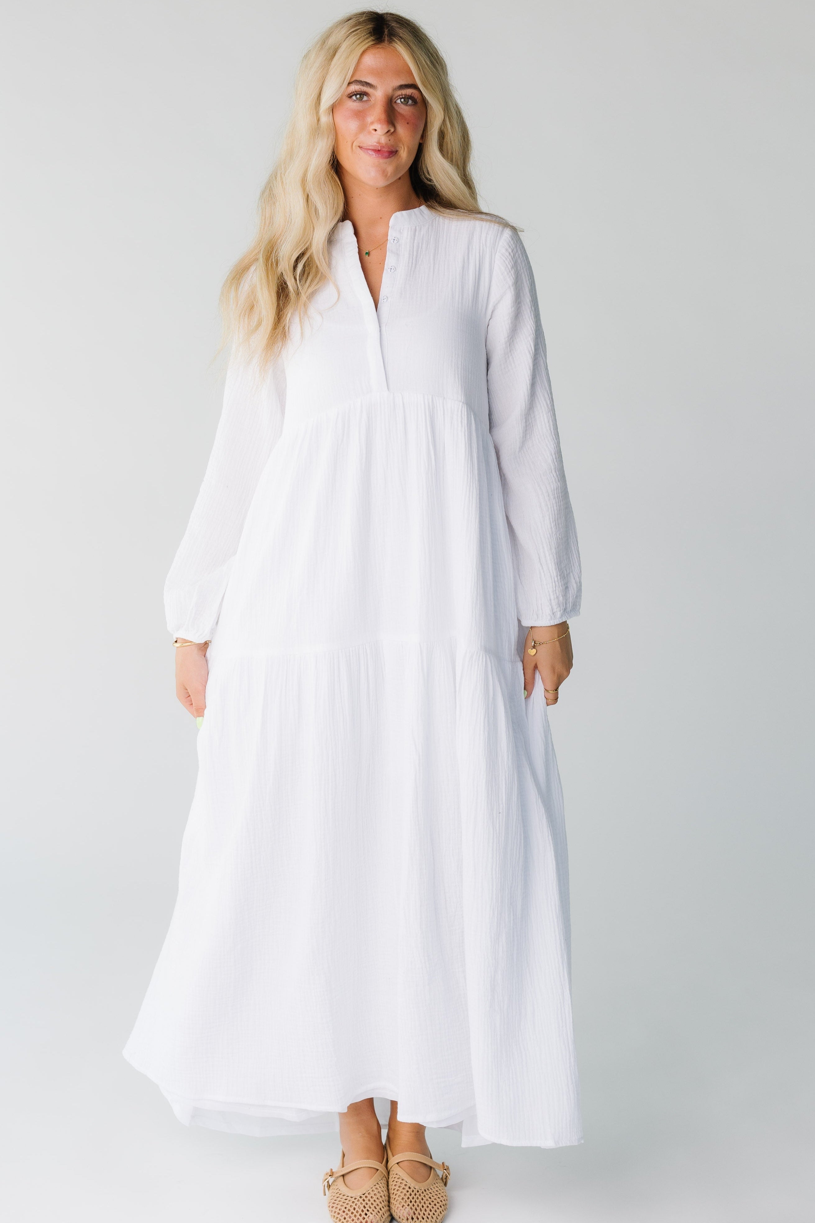 Modest women's white maxi dress with V-neckline and long sleeves