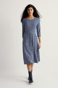 Woman wearing a floral organic cotton dress on a white background