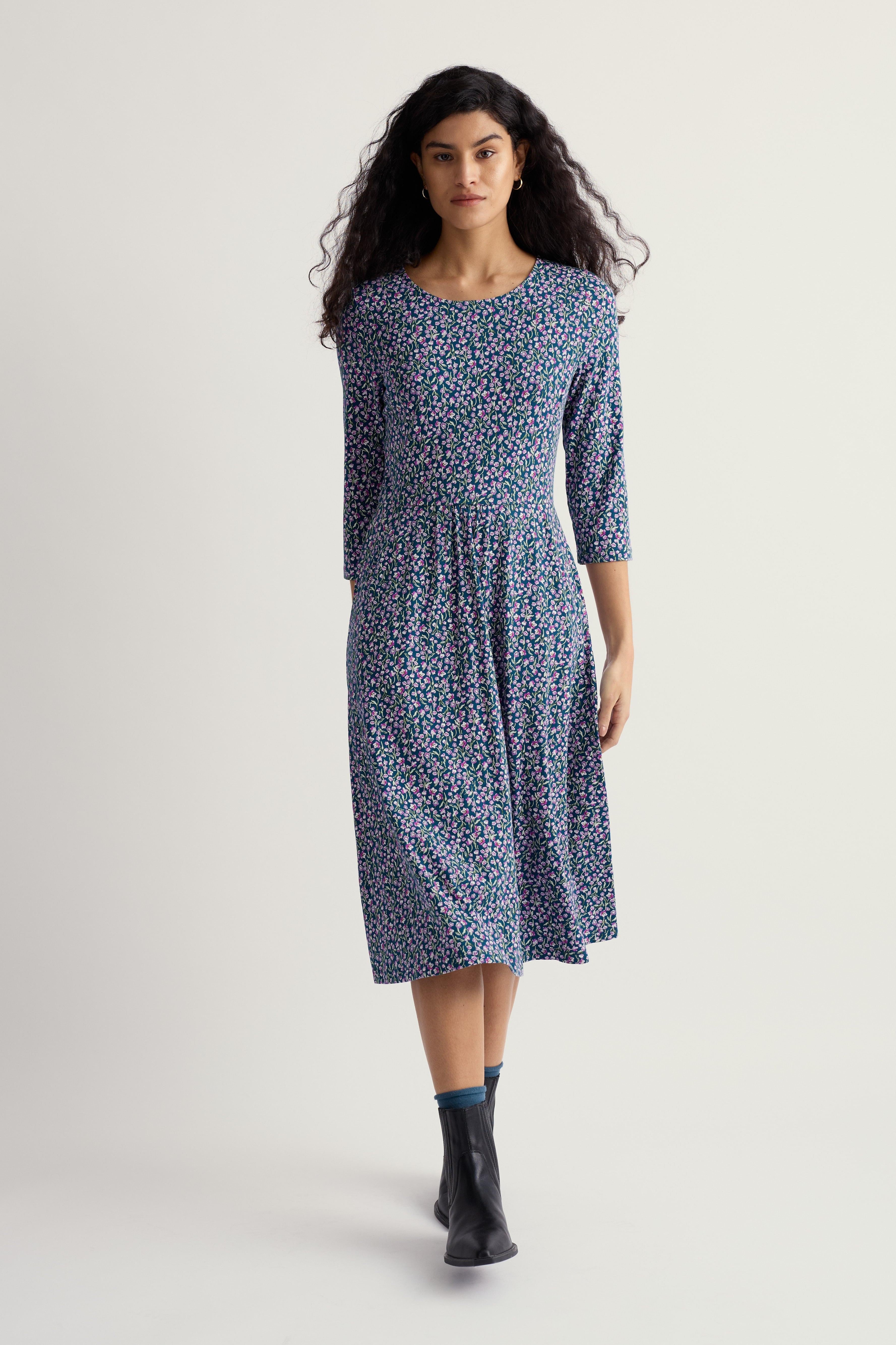 Woman wearing a floral organic cotton dress on a white background